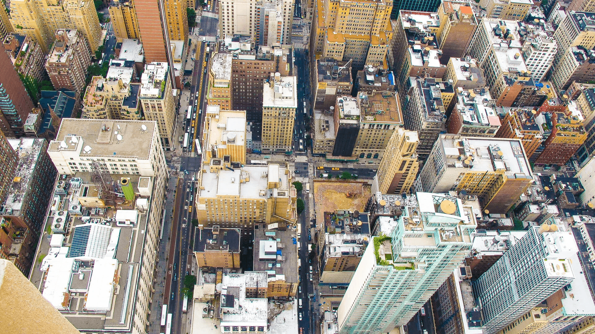 Available markets Aerial shot of a bustling cityscape with tall buildings and busy streets, showcasing the density and complexity of urban